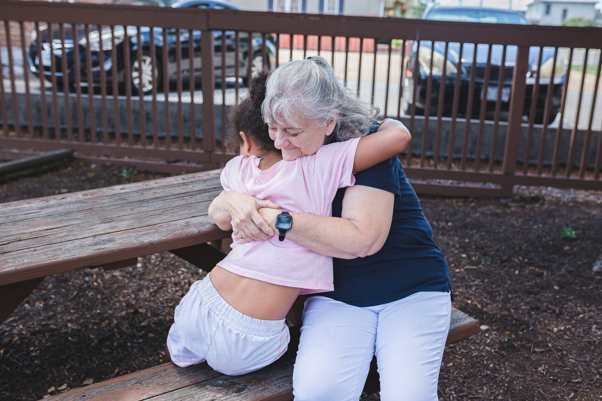 Mercy House staff hugging a child